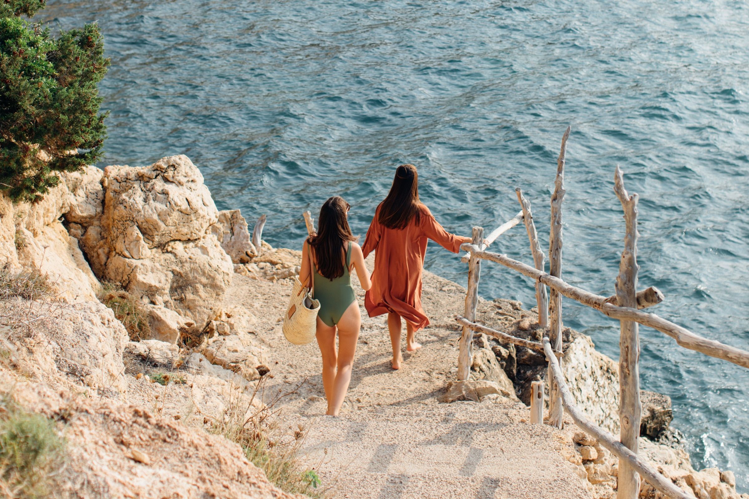 Two friends on their way to the beach from their luxury villa in Ibiza
