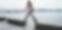 Woman-walking-along-a-stone-wall-by-the-sea-on-Greek-holiday