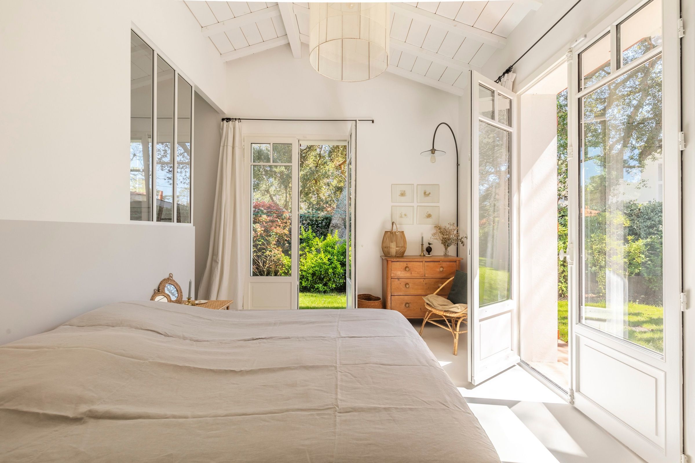 beige room with bay windows to a garden of a villa in the basque country