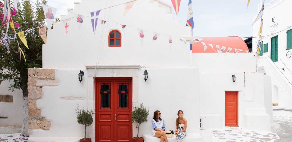 Friends sitting in a village in the Cyclades
