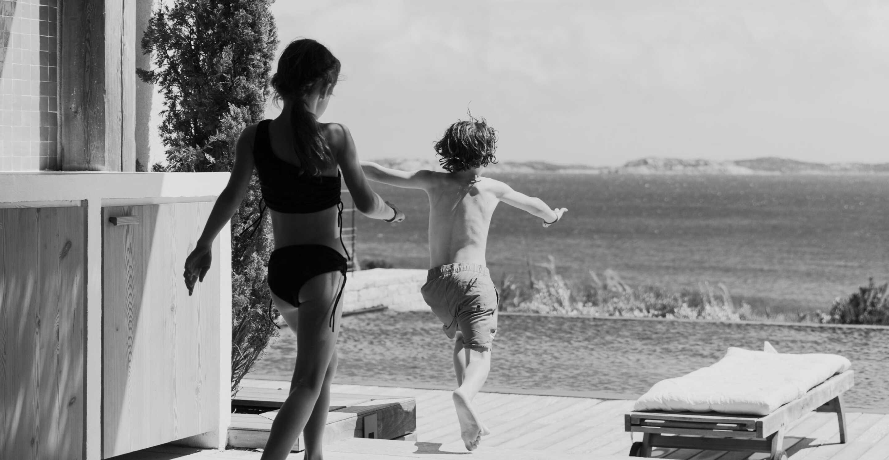 Family-with-children-by-a-waterfall-in-South-Corsica's-nature-in-summer