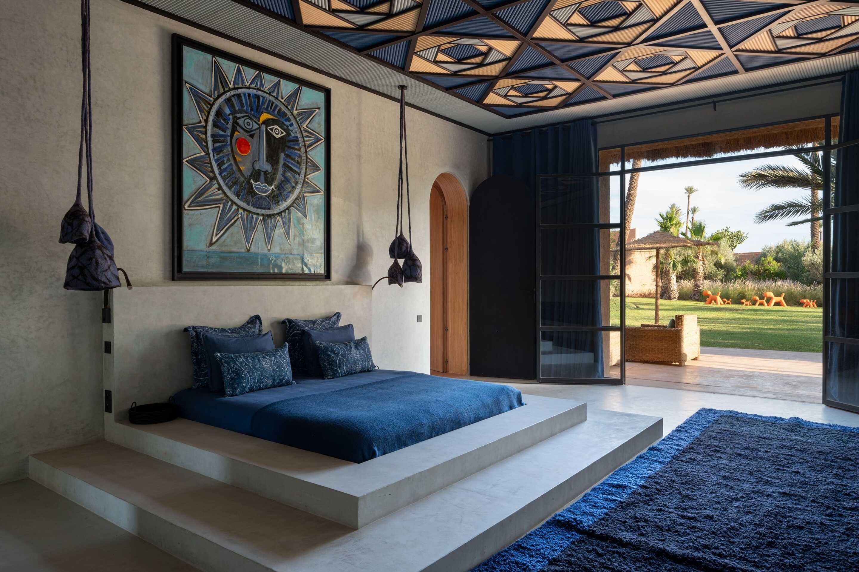 bedroom in villa with blue tones and outdoor terrace 