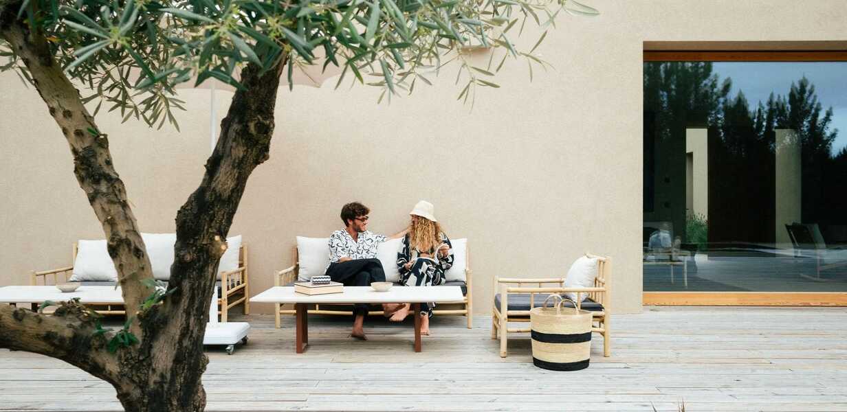 friends on a couch on the luxury winter sun villa terrace 