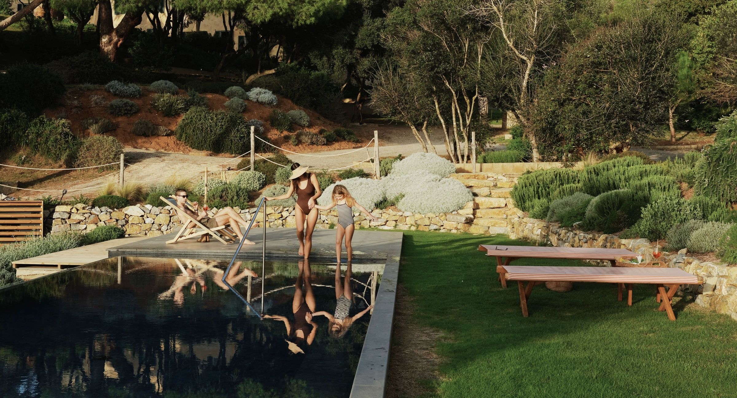 family enjoying an outdoor pool in summer