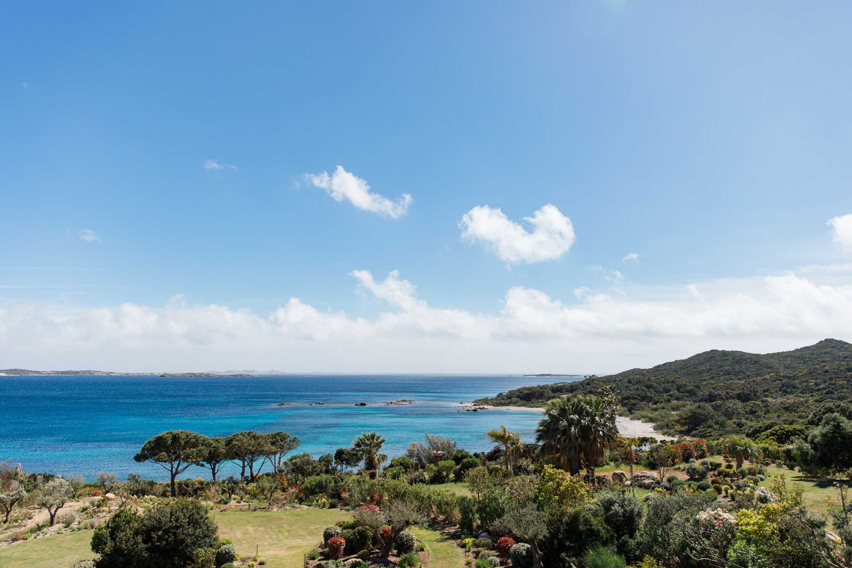 view-from-above-of-the-beach-of-a-green-island-facing-the-turquoise-sea