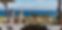 group-of-friends-on-the-wooden-terrace-of-a-luxury-villa-on-an-island-chatting-with-a-panoramic-view-on-the-sea-in-the-background