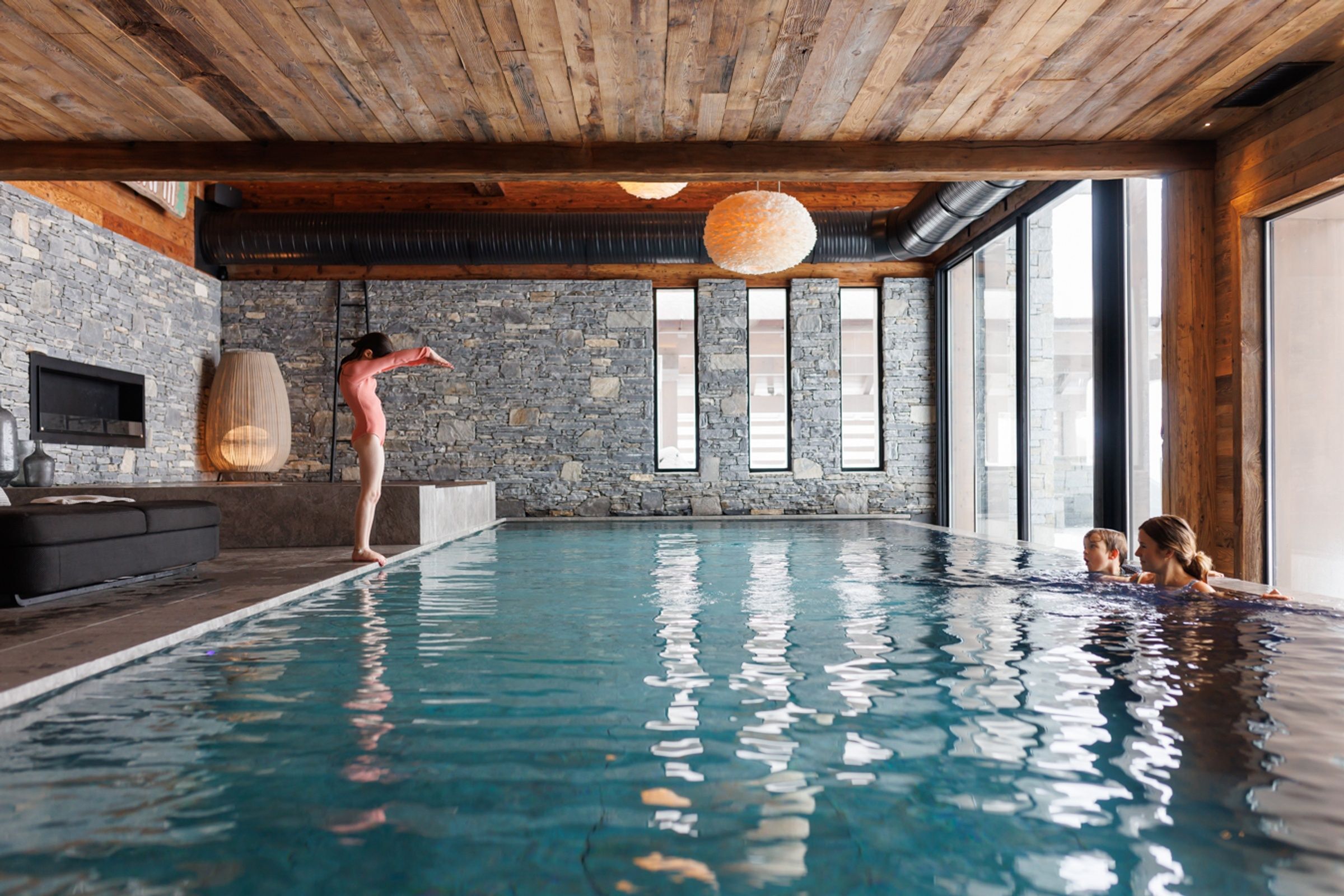 two girls in a heated pool in a luxury chalet