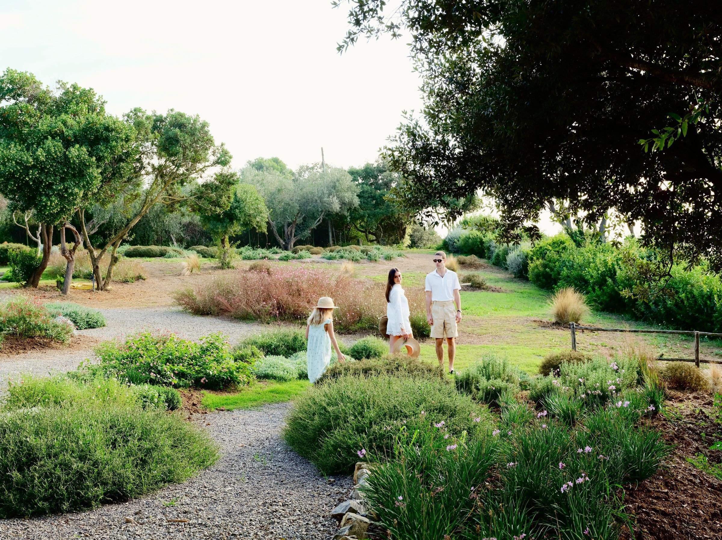 papa-maman-et-petite-fille-se-promenant-dans-un-jardin-verdoyant-en-été