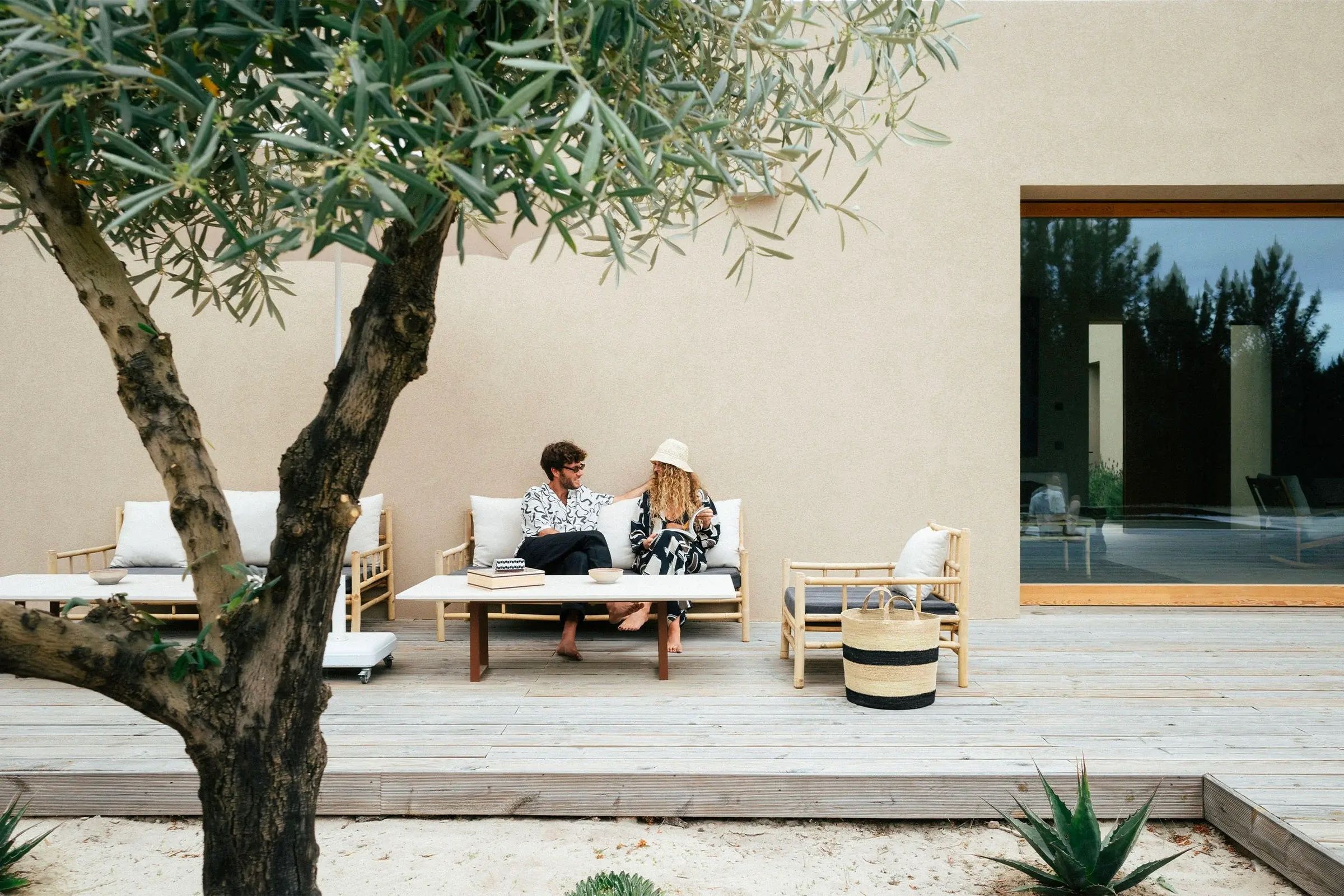 friends on a couch on the luxury winter sun villa terrace 
