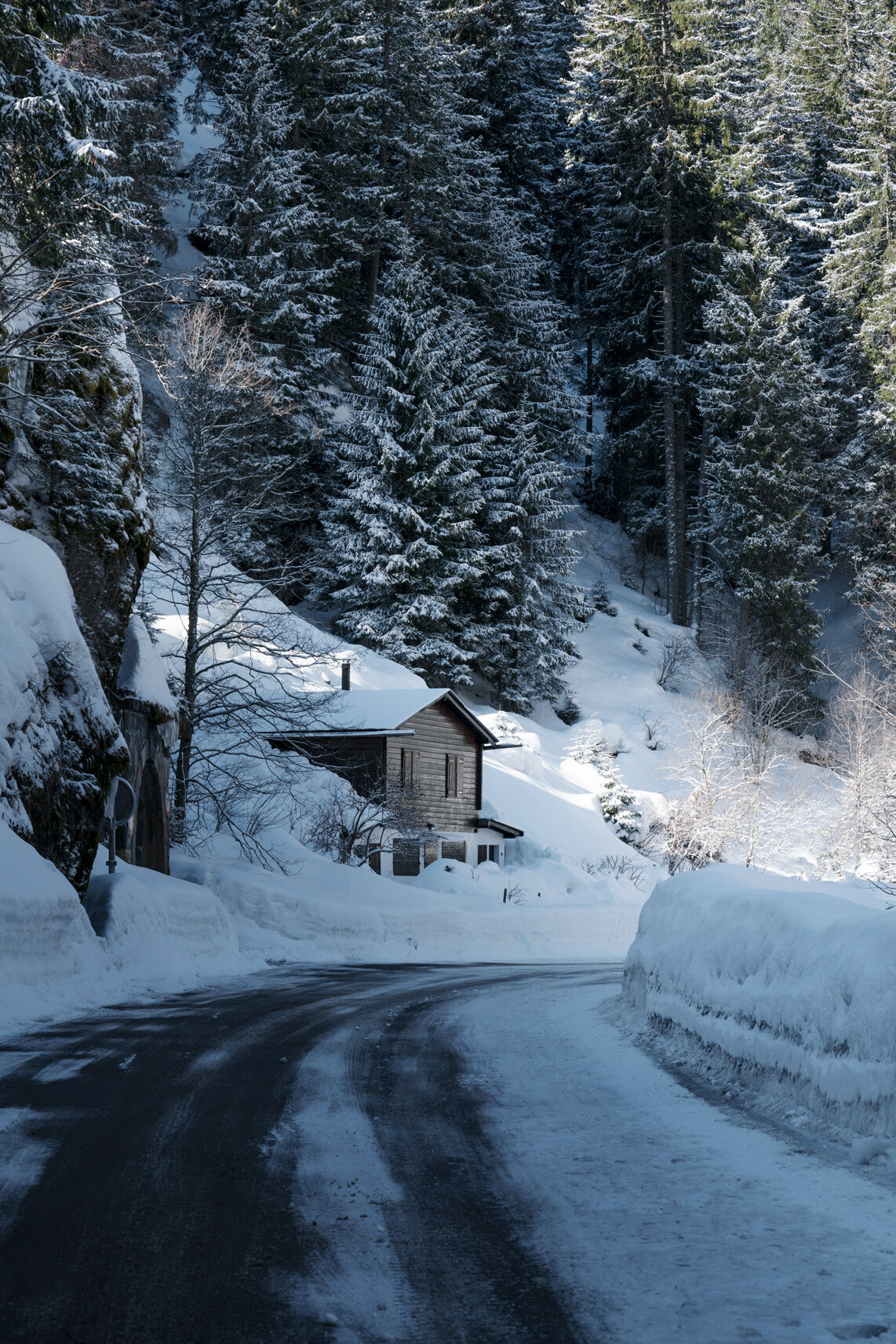 View from a snowy road of a luxury chalet in Verbier