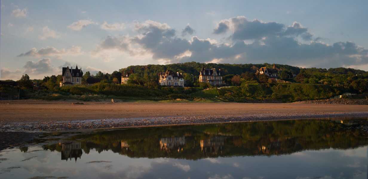 normandy-landscape-with-the-sea-a-sandy-beach-and-a-countryside-village-on-the-background